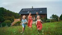 Happy Family running in front of Home with solarpanels
